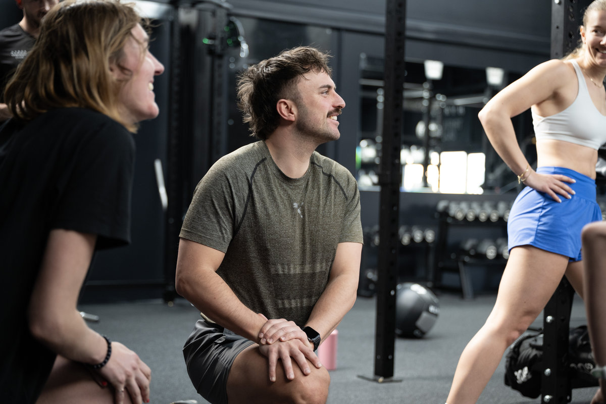 Members connecting and chatting in the welcoming gym environment at Inclusive Fitness