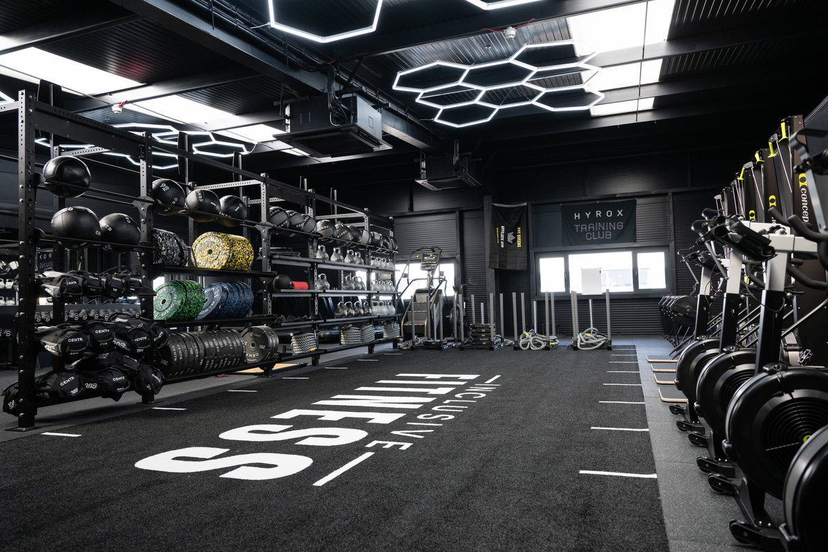 Modern, well-equipped gym floor at Inclusive Fitness with professional lighting and organized equipment